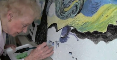 Volunteer paints ceiling tile at Sunnybrook