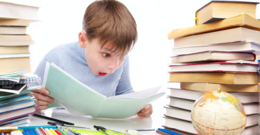 A boy with a messy desk who is overwhelmed