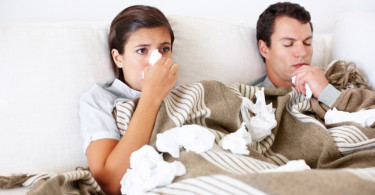 A couple in bed with allergies