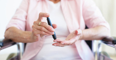 woman performing a blood sugar test