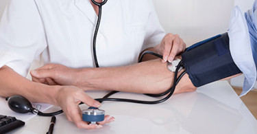 A person gets their blood pressure checked