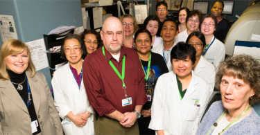 Laboratory staff, including Chris Lee, a bladder cancer survivor