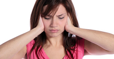 A girl holding her ears