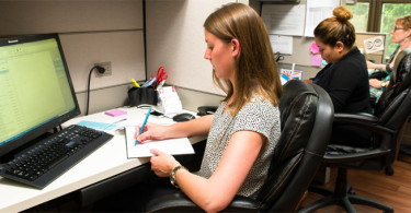 Woman writing at desk