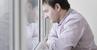 Man staring out window