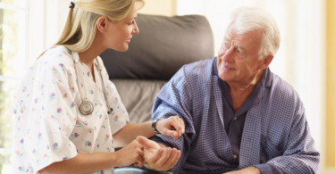 Nurse supporting a patient at home