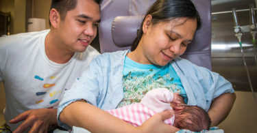 woman breastfeeding her baby