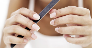 close-up of a woman filing her nails