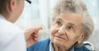 woman getting a hearing aid fitted