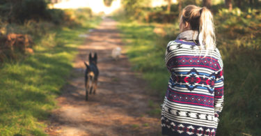 Woman walking through forest