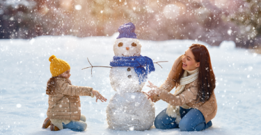 mom and child building a snowman