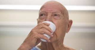 Patient drinks water for the first time since he was diagnosed with essential tremor