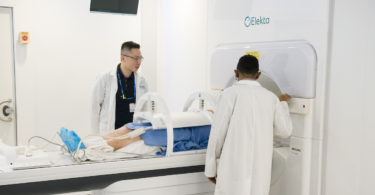 radiation therapist adjust patient on MR-Linac