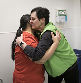 France gives a hug to patient, Mary Ybanez.