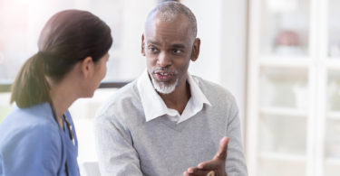 Man speaking with a health-care provider