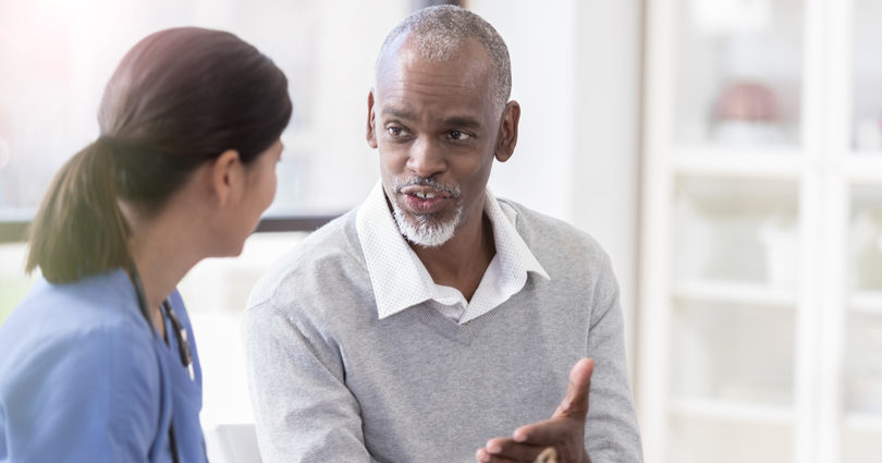 Man speaking with a health-care provider