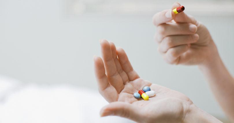 woman holding pills