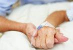 holding hands in the critical care unit