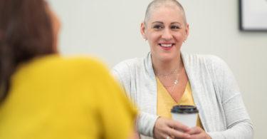 woman with breast cancer talking with research assistant