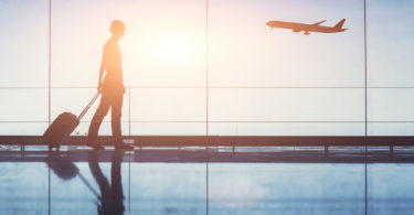 woman in silhouette at airport