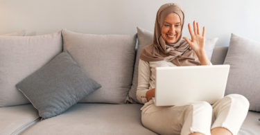 A woman video chats with loved ones.