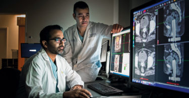 Medical physicist Ananth Ravi (left) and radiation oncologist Dr. Eric Leung review imaging from the MRI-Brachytherapy Suite