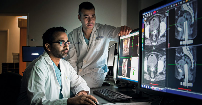 Medical physicist Ananth Ravi (left) and radiation oncologist Dr. Eric Leung review imaging from the MRI-Brachytherapy Suite