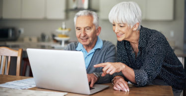 Two people using a laptop computer for a video call