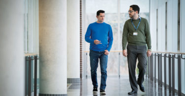 Alan MacDonald (left) walks with clinical psychologist Dr. Sam Iskandar at St. John’s Rehab.