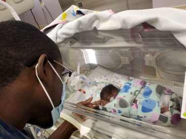 Akeem Richards visits with his child in the NICU.