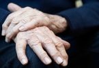 Closeup Of Senior Man Suffering With Parkinson's Disease