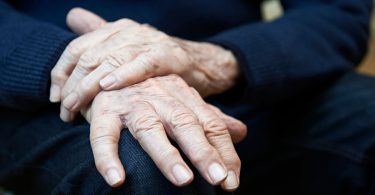 Closeup Of Senior Man Suffering With Parkinson's Disease