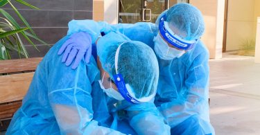 health-care worker comforts colleague during pandemic