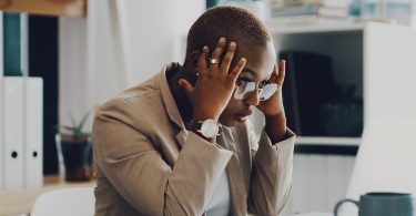 woman overwhelmed looking at computer