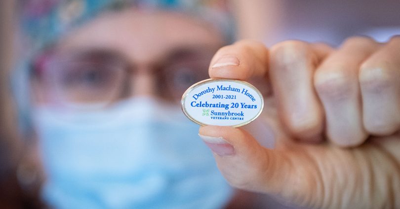 A nurse holds a button.