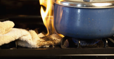 towel accidentally catches fire on stove