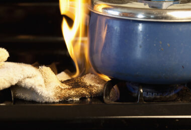 towel accidentally catches fire on stove